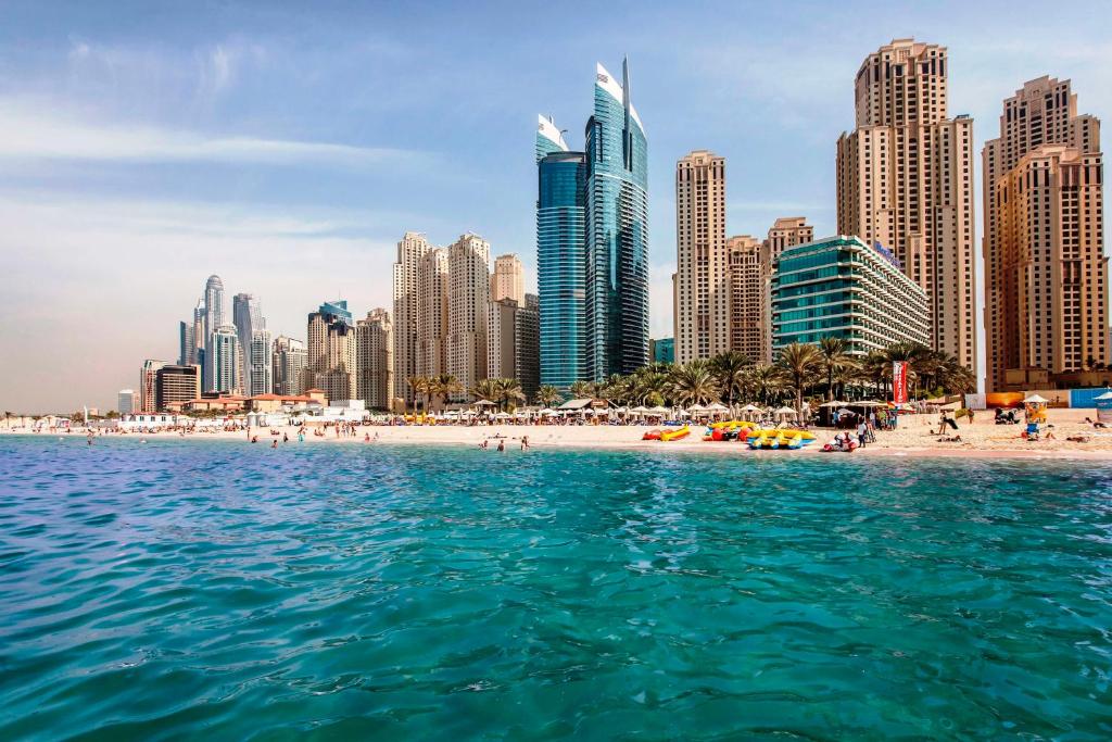 a view of a beach in front of a city at Hilton Dubai Jumeirah in Dubai
