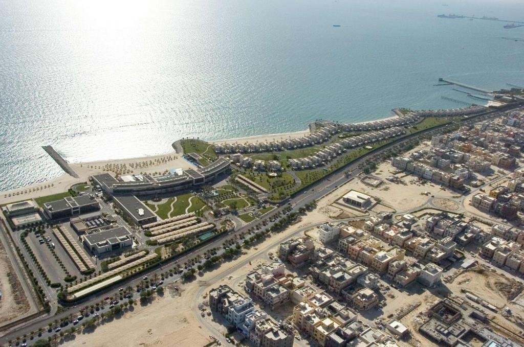 an aerial view of a resort next to the ocean at Hilton Kuwait Resort in Kuwait