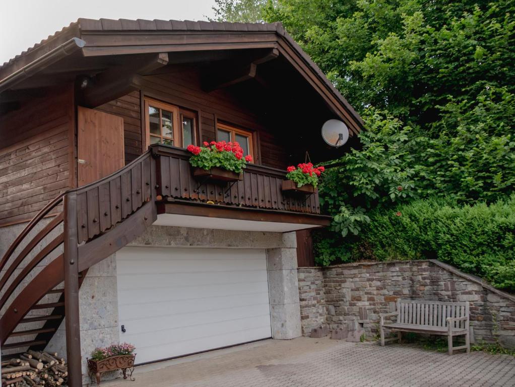 a house with a balcony and a garage at Erika´s Häuschen in Kitzbühel