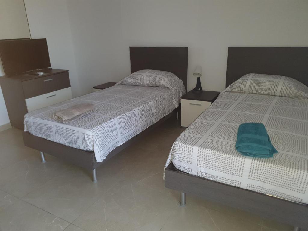 two beds in a room with two beds sidx sidx sidx at Menhir in Kirkop