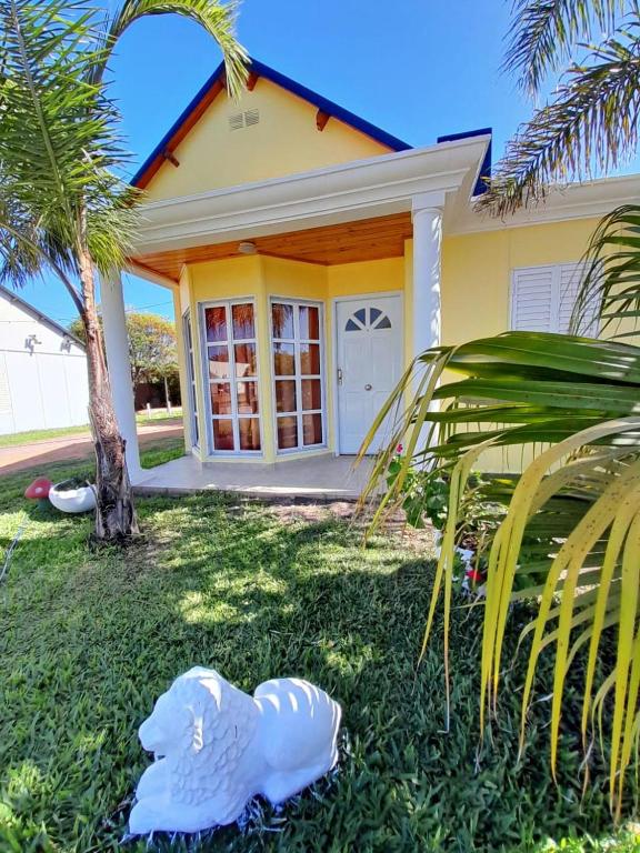 a house with a white bird statue in front of it at Casitas del Sol in Caseros