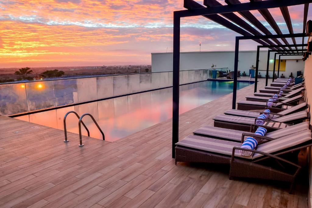 a swimming pool on the roof of a building at Hilton Garden Inn Nairobi Airport in Nairobi