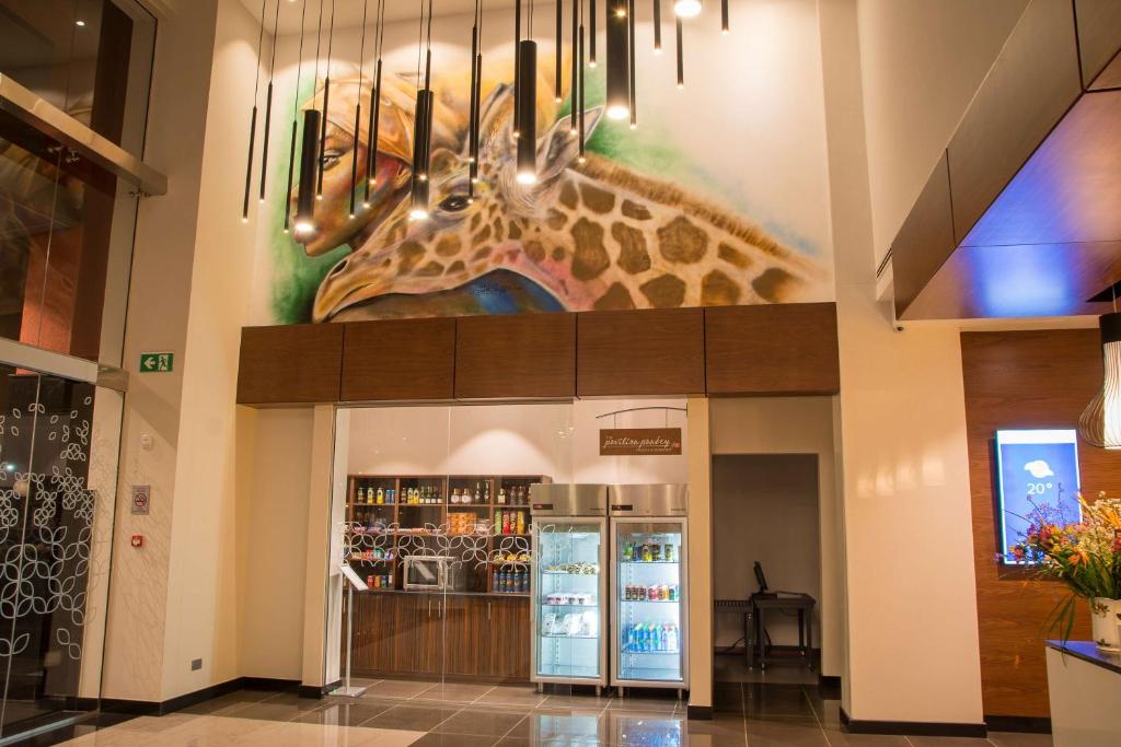 a giraffe painting on the wall of a building at Hilton Garden Inn Nairobi Airport in Nairobi