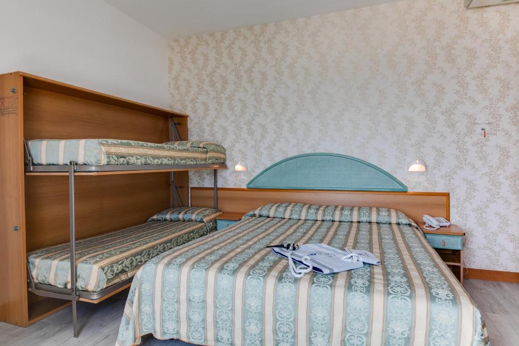 Postel nebo postele na pokoji v ubytování Hotel Cigno D'Oro