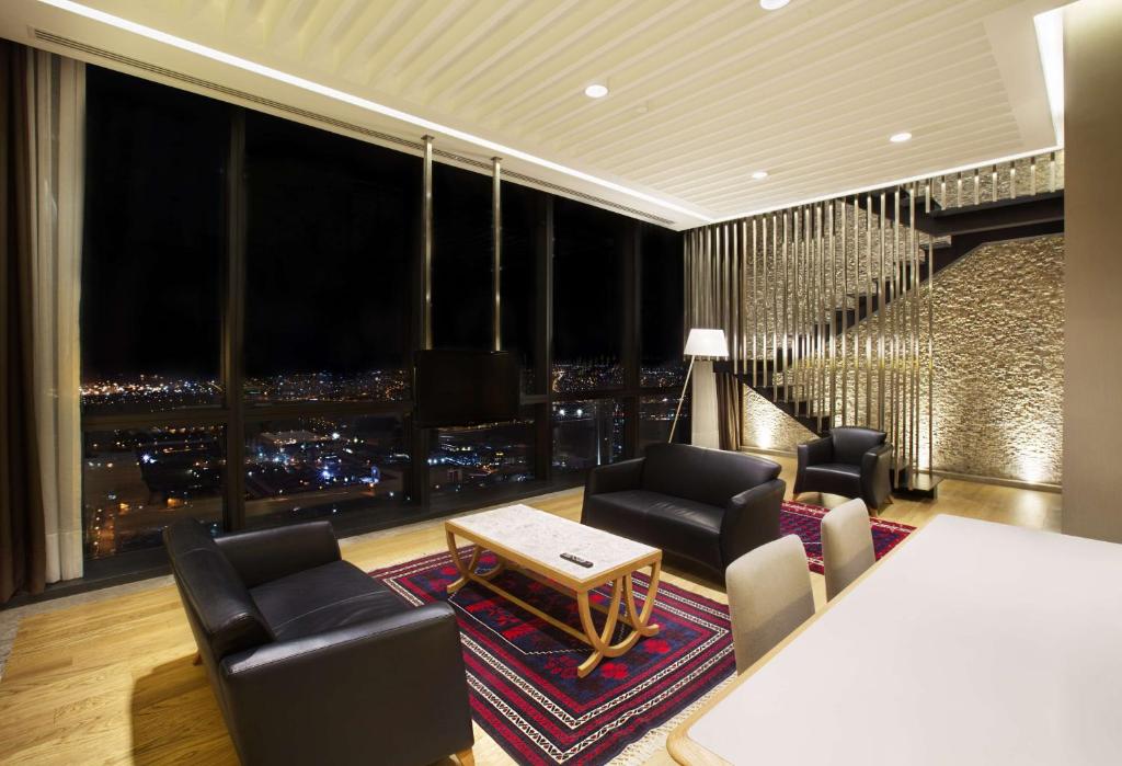 a living room with a view of a city at DoubleTree by Hilton Istanbul-Avcilar in Istanbul