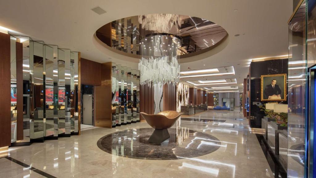 a lobby with a chandelier in the middle of a store at Hilton Istanbul Maslak in Istanbul