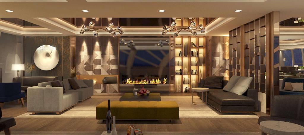 a living room with couches and a fireplace at Hilton Istanbul Maslak in Istanbul