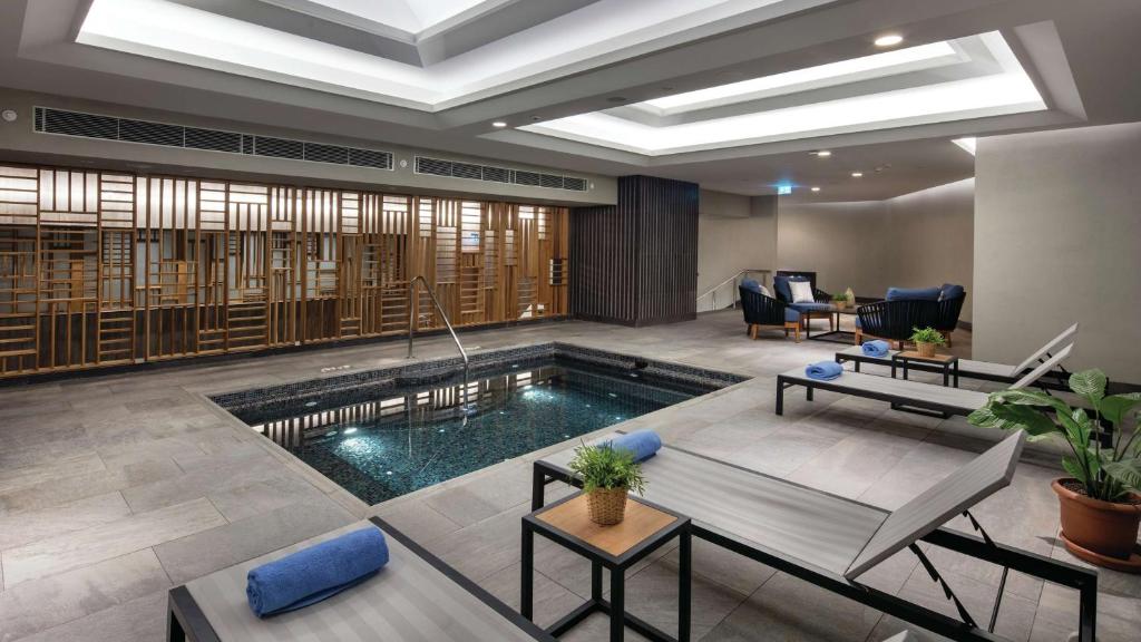 a living room with a swimming pool in a house at Hilton Istanbul Maslak in Istanbul