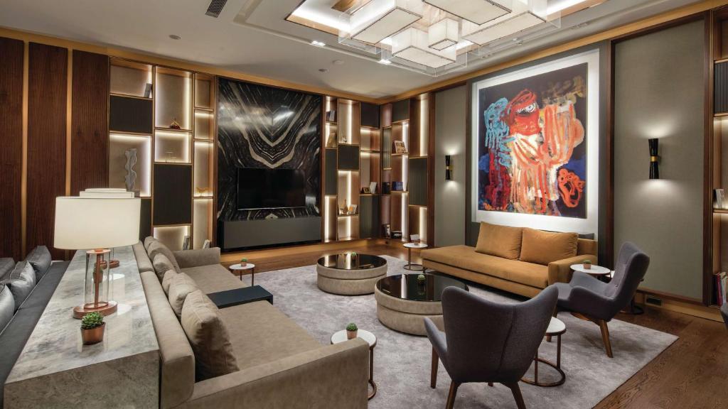 a living room with a couch and a table at Hilton Istanbul Maslak in Istanbul