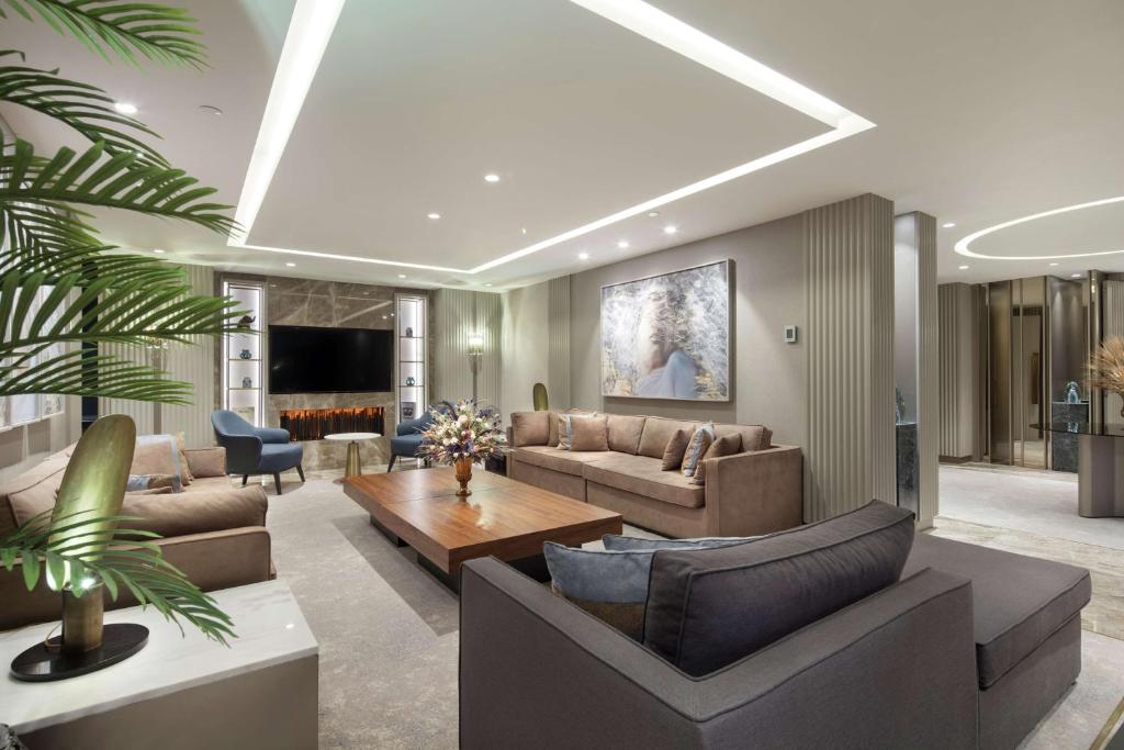 a living room with a couch and a table at Hilton Istanbul Maslak in Istanbul