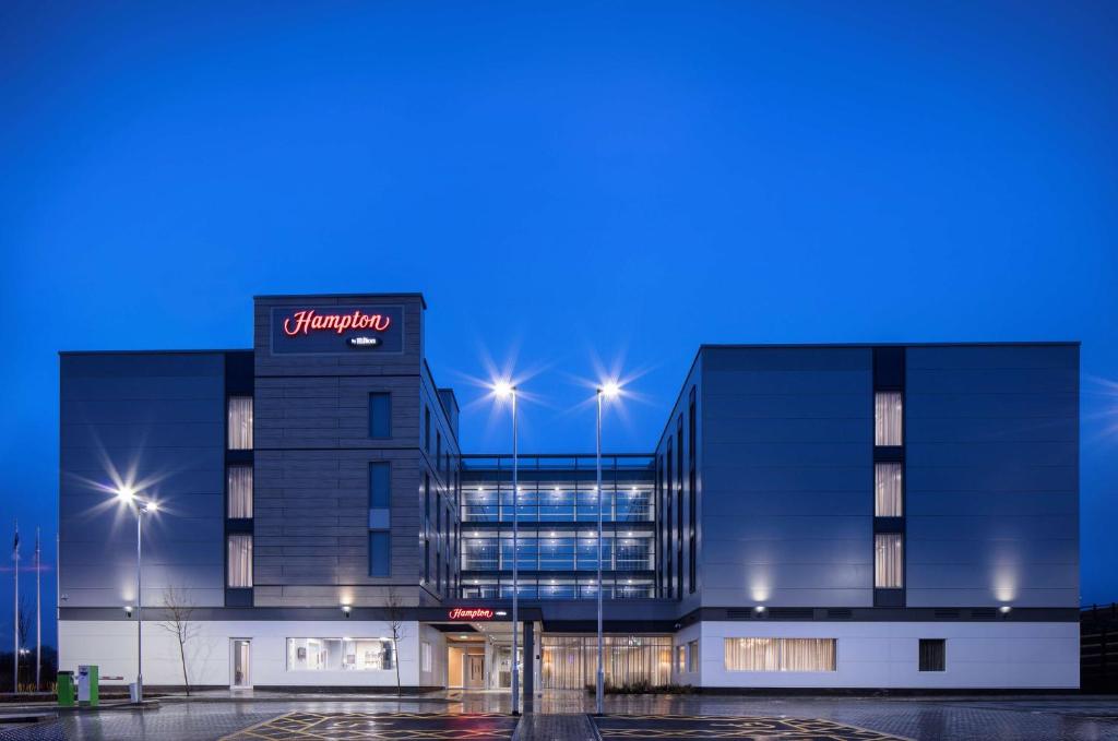 a building with a sign on the side of it at Hampton By Hilton Bristol Airport in Redhill