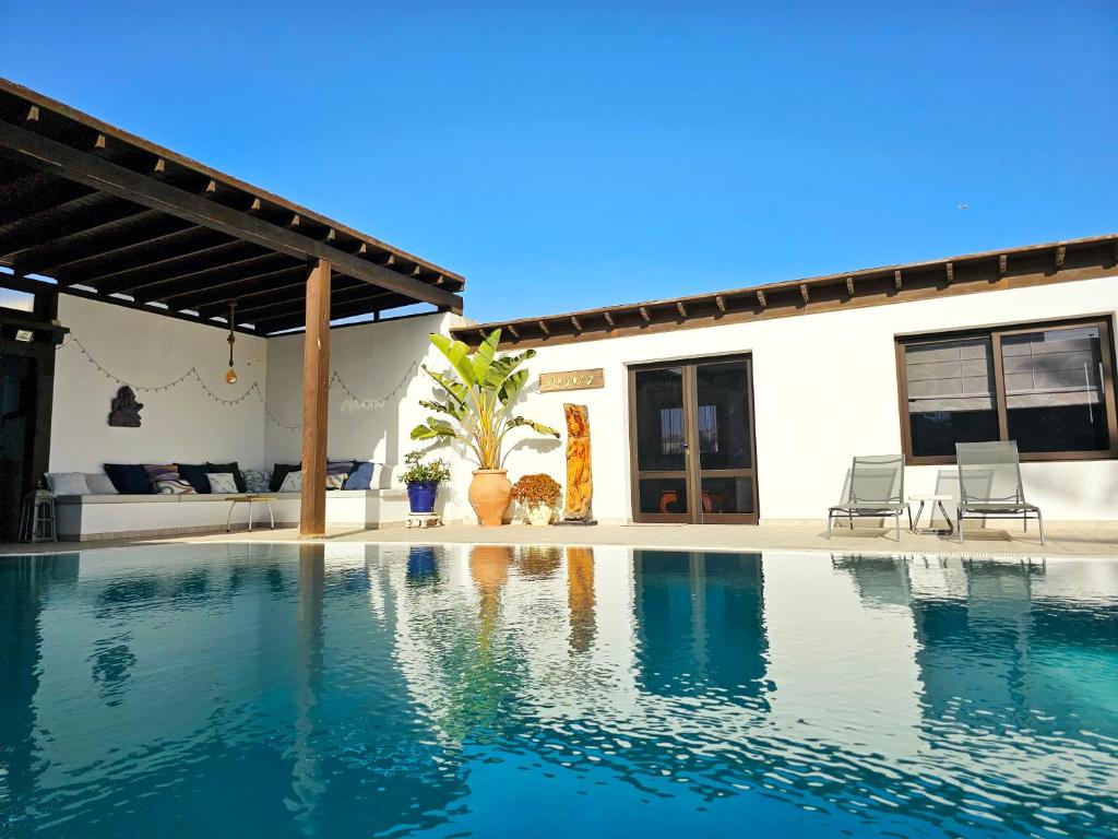 a swimming pool in front of a house at Villa Nazoly in Nazaret