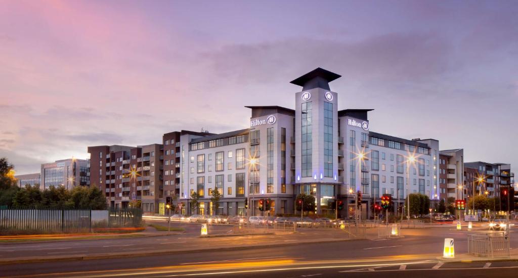 a large building on a city street at night at Hilton Dublin Airport in Cloghran