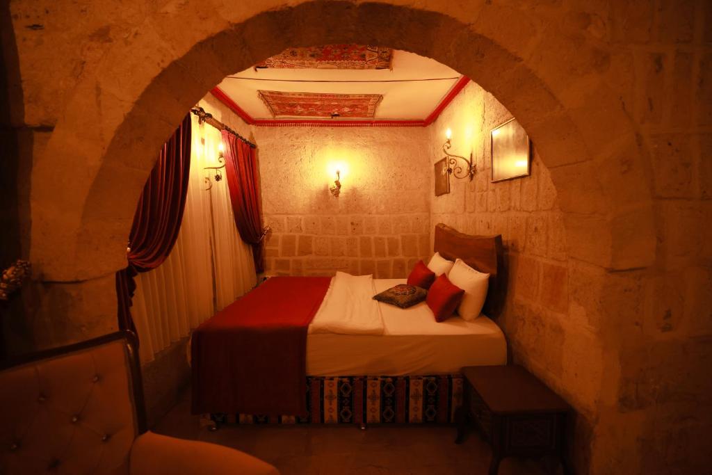 A bed or beds in a room at Cappadocia Nar Cave House & Swimming Pool