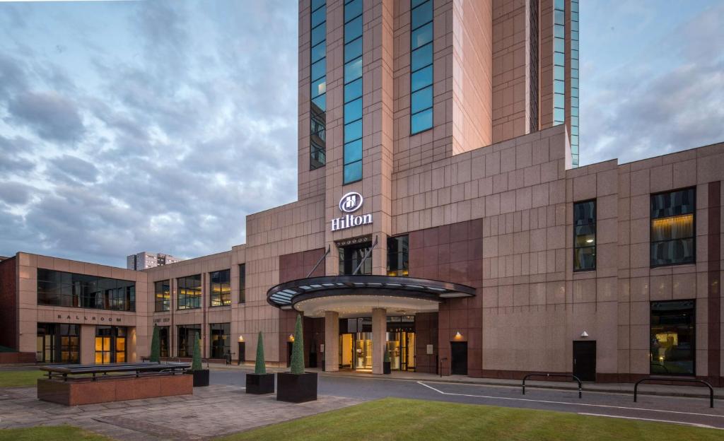 a large building with a clock tower in front of it at Hilton Glasgow in Glasgow