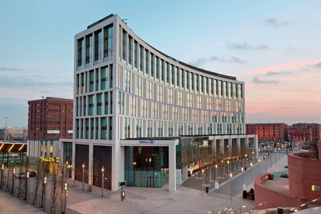 Un grand bâtiment blanc avec de nombreuses fenêtres dans l'établissement Hilton Liverpool City Centre, à Liverpool