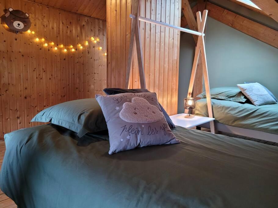 a bedroom with a bed with a pillow on it at Maison Les Planches in Gérardmer