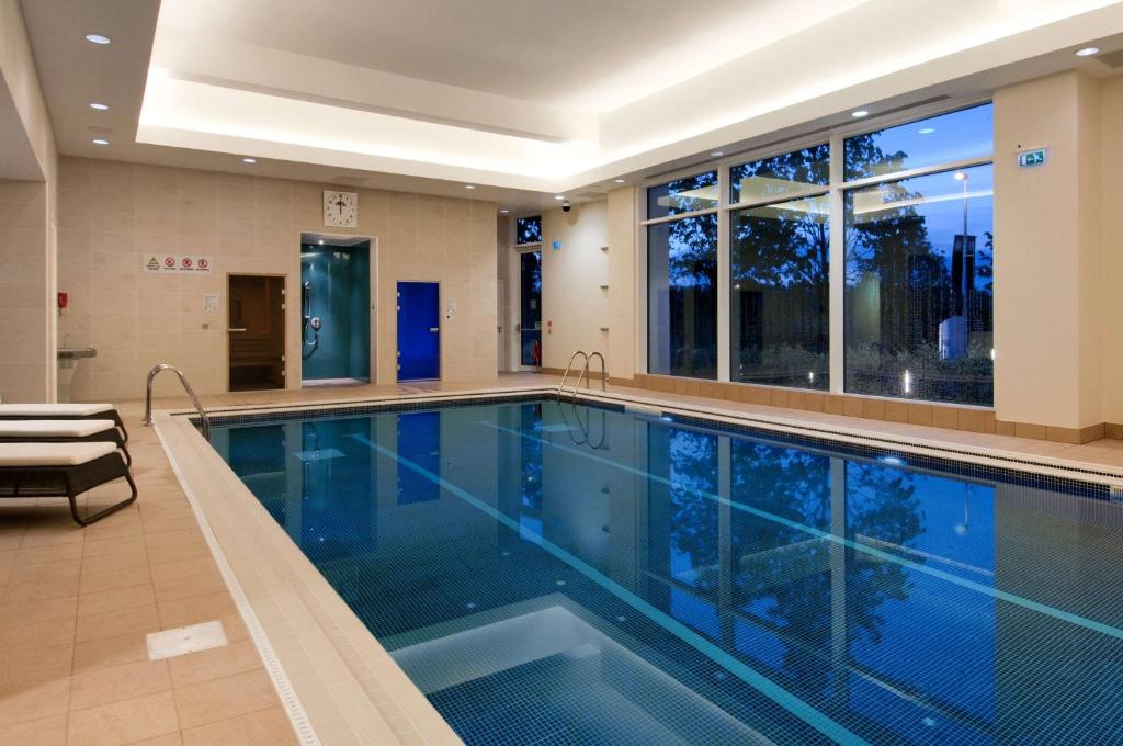 a swimming pool in a building with a large window at Hilton Reading in Reading