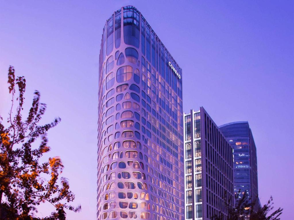 a tall building with a lot of windows on it at Conrad Beijing by Hilton in Beijing