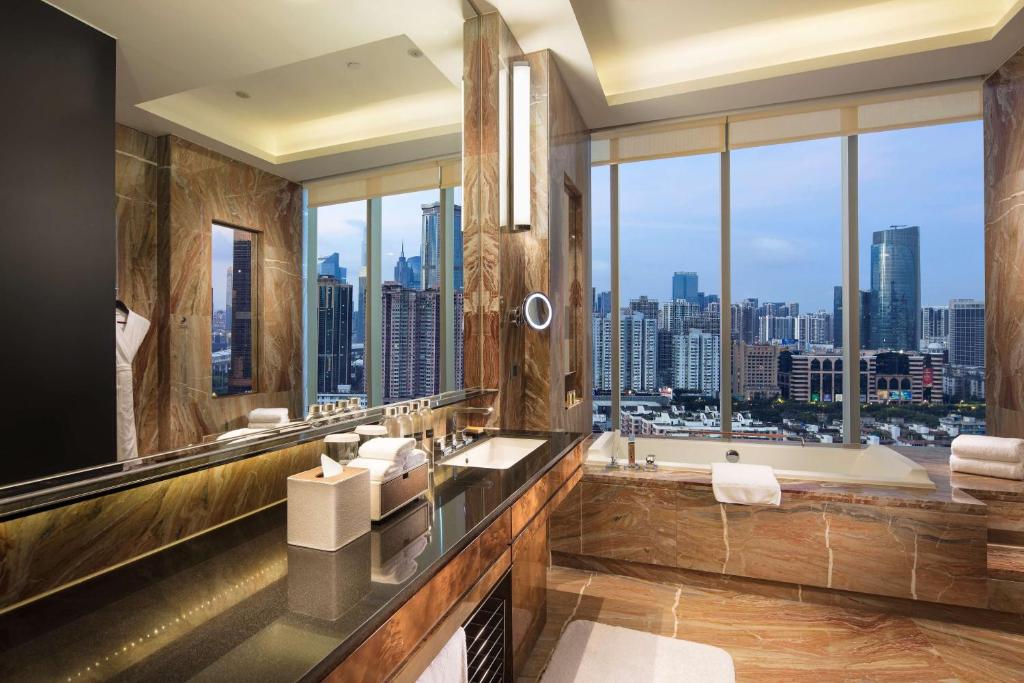 a bathroom with a tub and a large window at Hilton Guangzhou Tianhe - Free Canton Fair Shuttle Bus and Registration Counter in Guangzhou