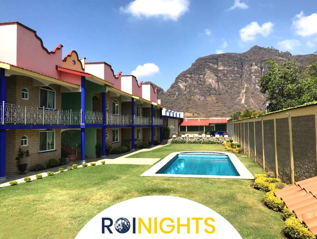 a resort with a swimming pool and mountains in the background at Bungalows Boutique Tonantzin in Morelos