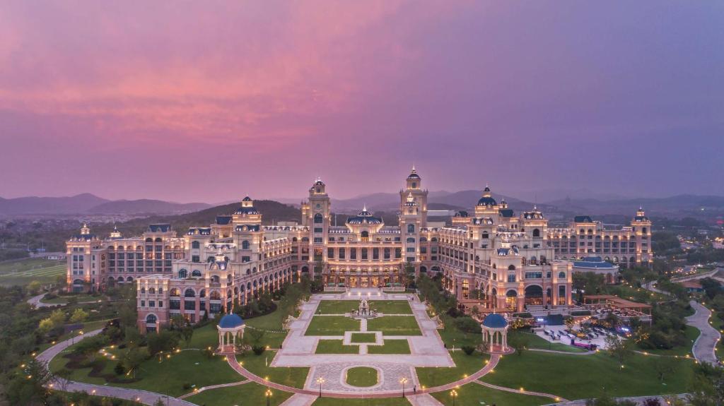 an aerial view of a large building at dusk at Hilton Dalian Golden Pebble Beach Resort in Jinzhou