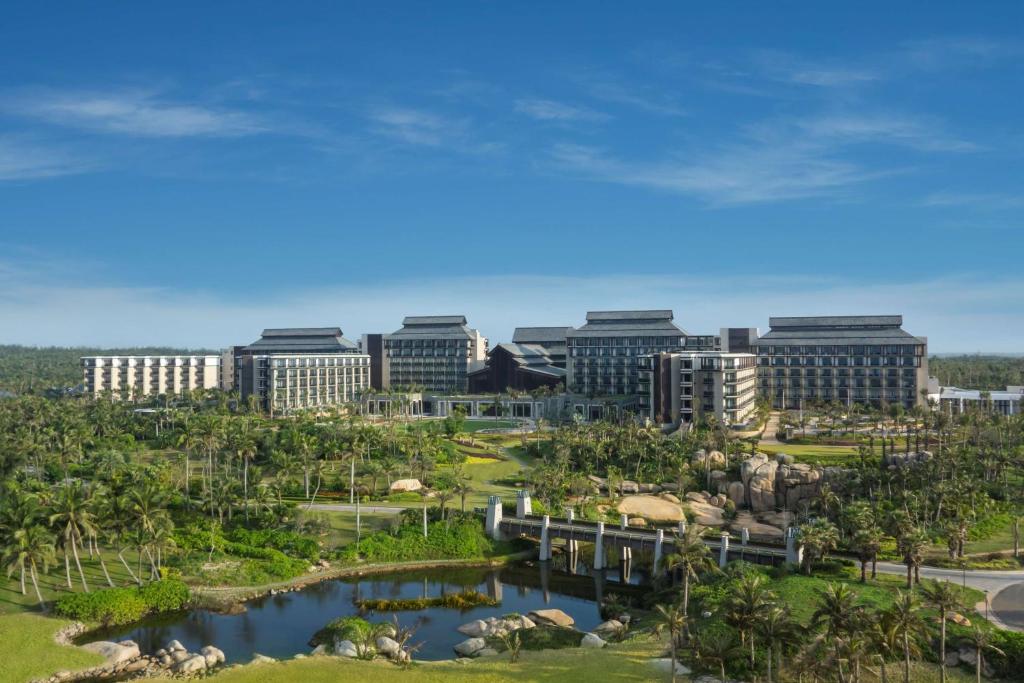 a view of a resort with buildings in the background at Hilton Wenchang in Wenchang