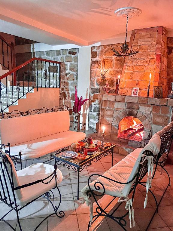 a living room with a table and a fireplace at Dar Bakkali Nadi in Tangier