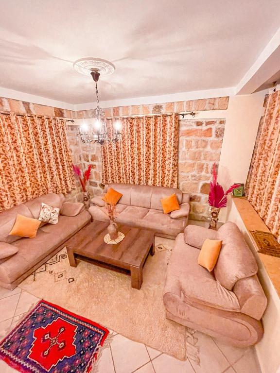 a living room with two couches and a table at Dar Bakkali Nadi in Tangier