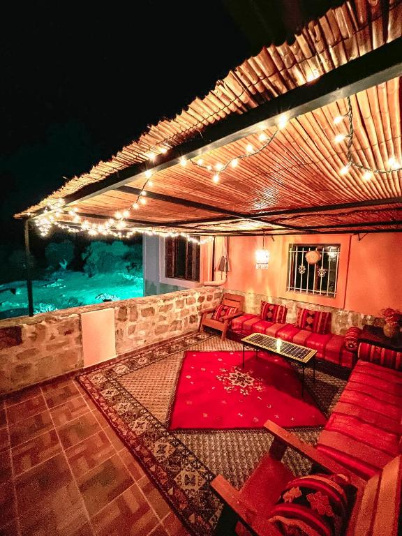 a living room with red couches and a red rug at Dar Bakkali Nadi in Tangier