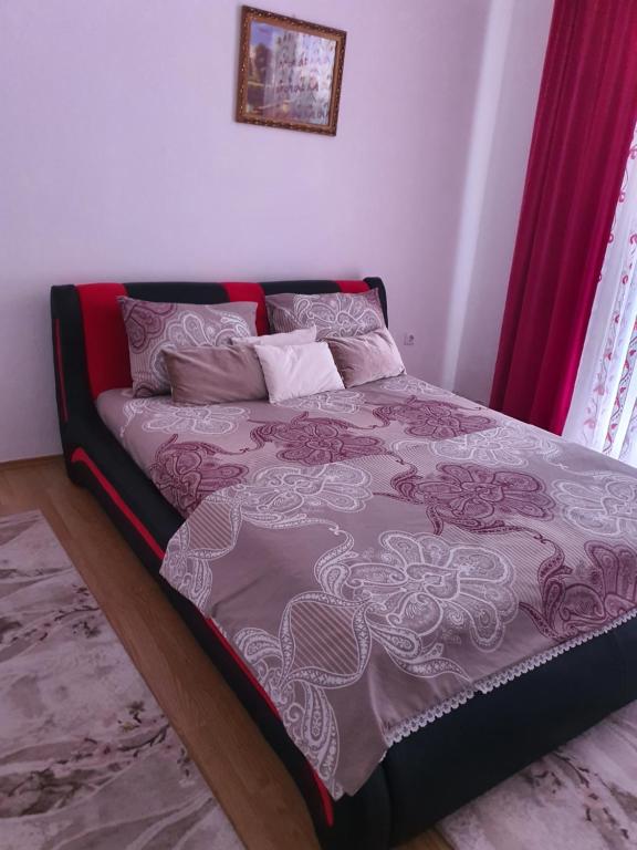 a bed in a bedroom with pink and white sheets at Kuća na dan aseea 