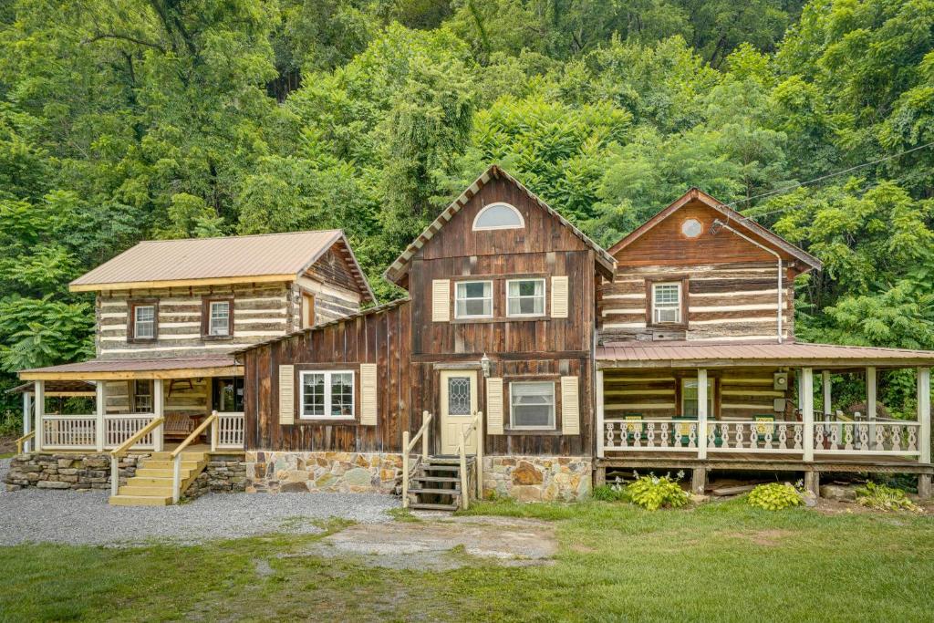 a large wooden house with a porch at Historic Cabin Retreat about 2 Mi to Seneca Rocks! in Seneca Rocks