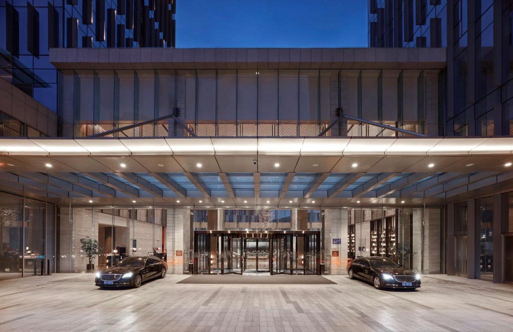 two luxury cars parked inside of a building at Hilton Guiyang in Guiyang