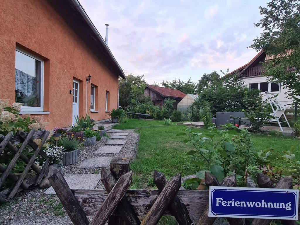 a yard with a fence and a house at Ferienwohnung Warnitz in Blankenburg Oberuckersee