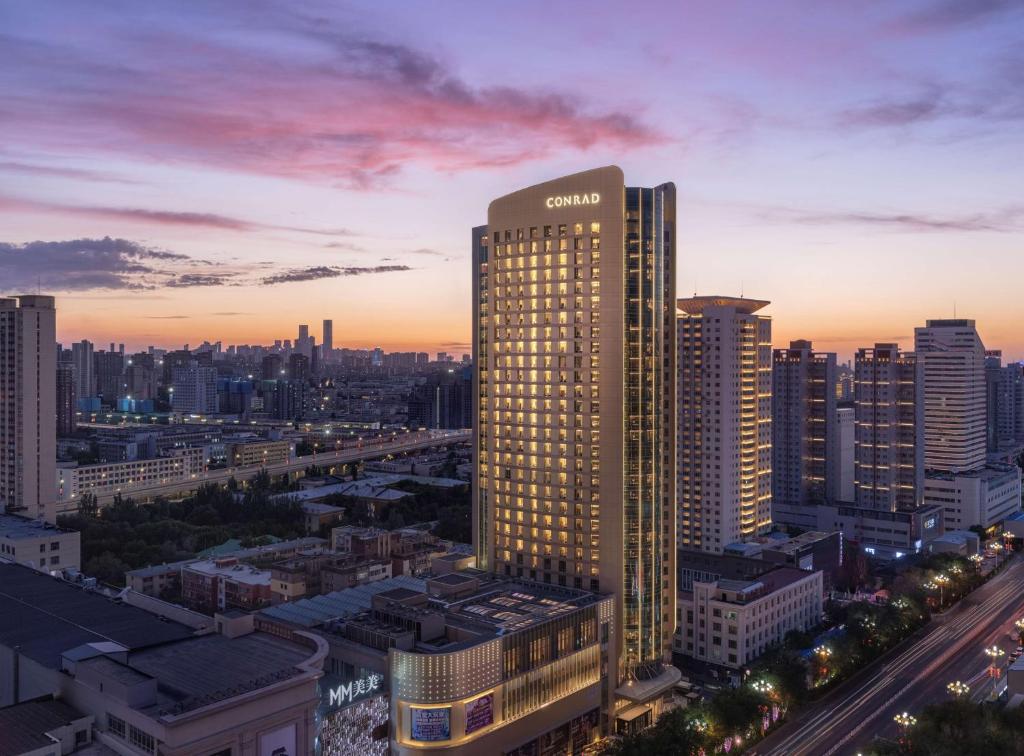 a sony building in a city at sunset at Conrad Urumqi in Ürümqi