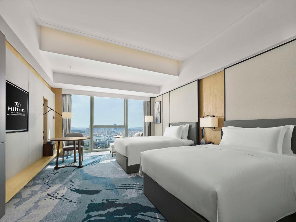 Postel nebo postele na pokoji v ubytování Hilton Foshan Shunde - Free Shuttle Bus to Canton Fair