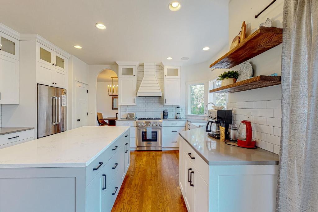 a kitchen with white cabinets and white counter tops at Soft Tail Sanctuary in Bend