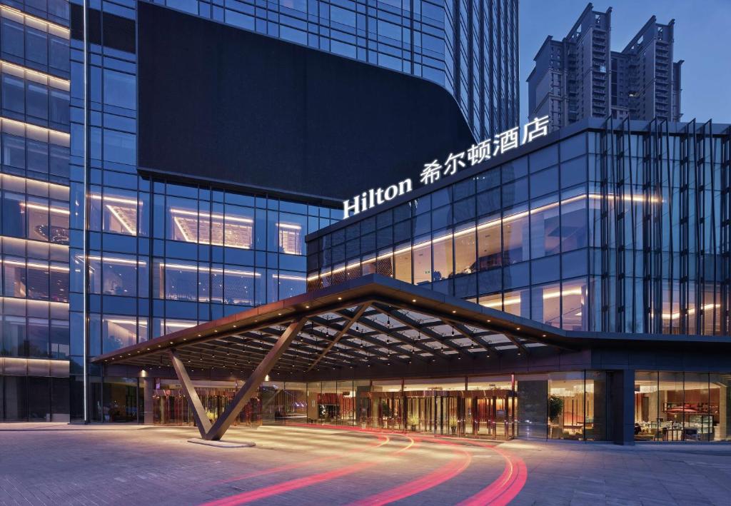 a building with a sign on the front of it at Hilton Shenyang in Shenyang