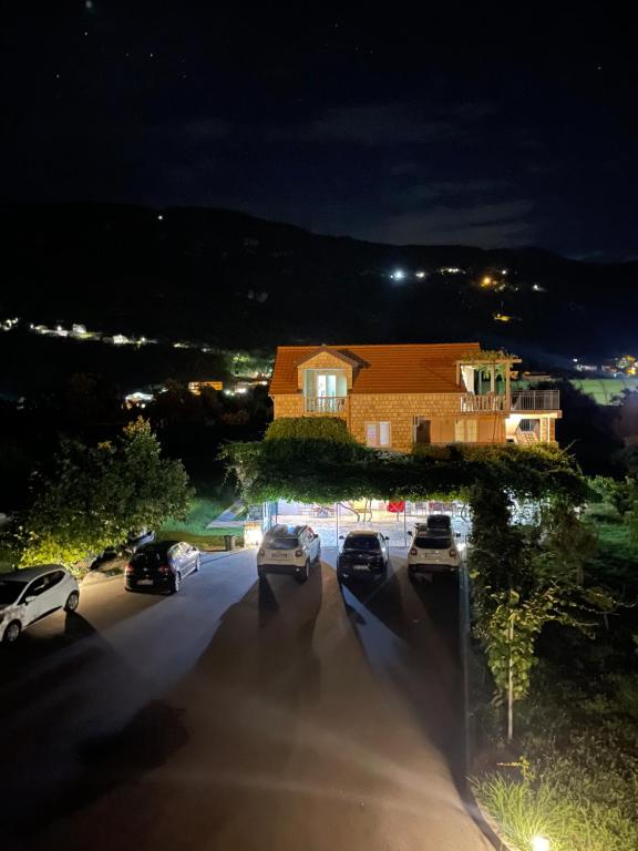 a group of cars parked in a parking lot at night at Apartmani Mendula in Budva