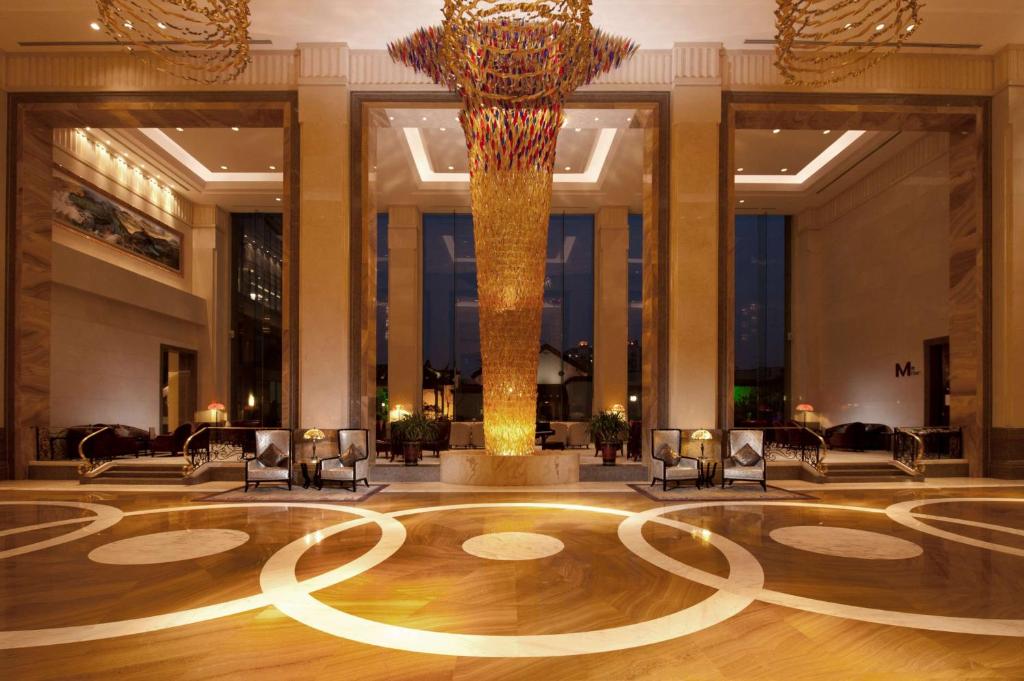 a lobby with a large chandelier in a building at DoubleTree By Hilton Wuxi in Wuxi