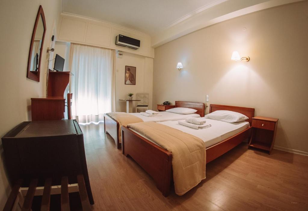 Postel nebo postele na pokoji v ubytování Hotel King Pyrros