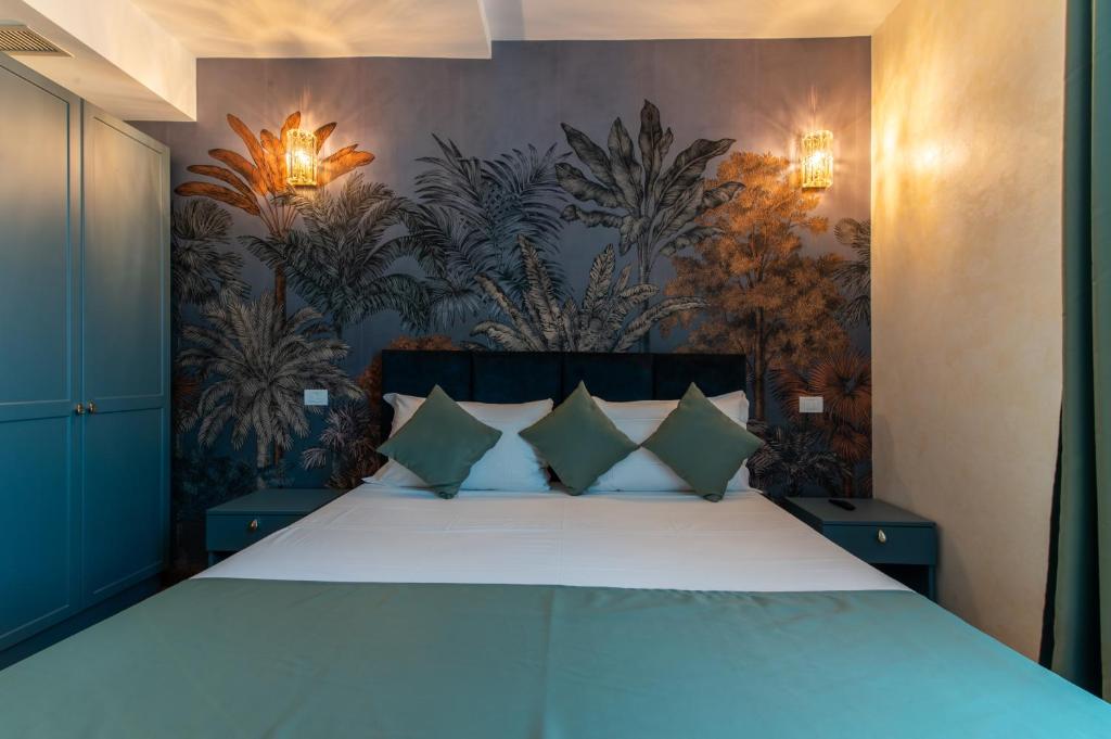 a bedroom with a large bed with green pillows at Villa Cesi Resort & Spa in Impruneta