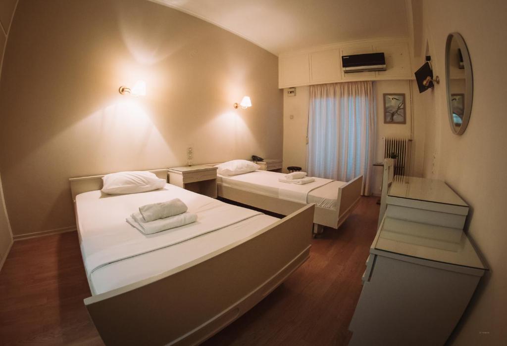 Postel nebo postele na pokoji v ubytování Hotel King Pyrros