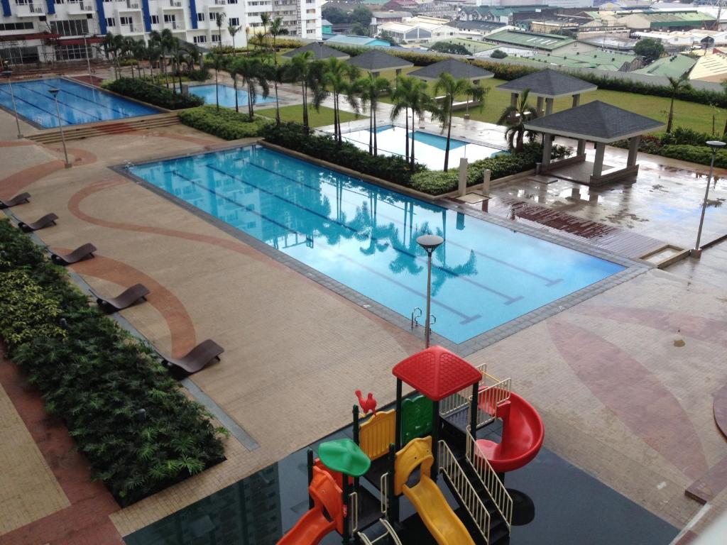 an overhead view of a swimming pool with a playground at Studio Units at SM Light Residences Condo Beside Boni MRT Station in Manila