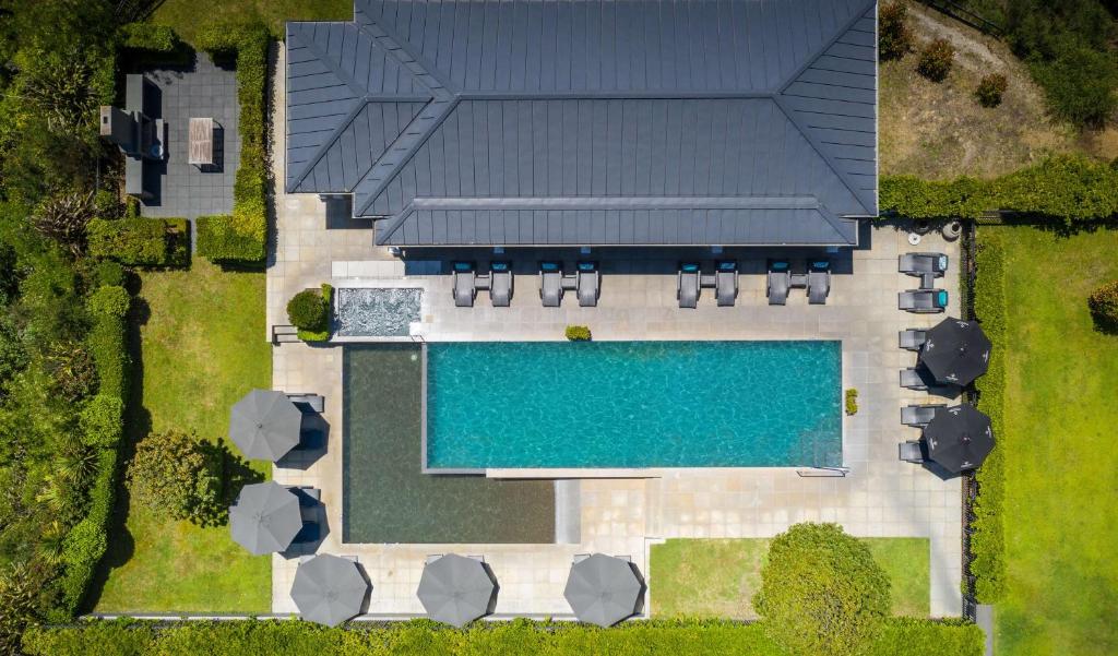 an aerial view of a house with a swimming pool at Hilton Lake Taupo in Taupo