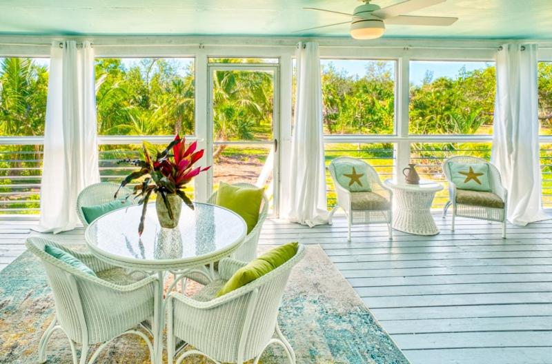 a living room with a table and chairs at Henderson home in Sanibel