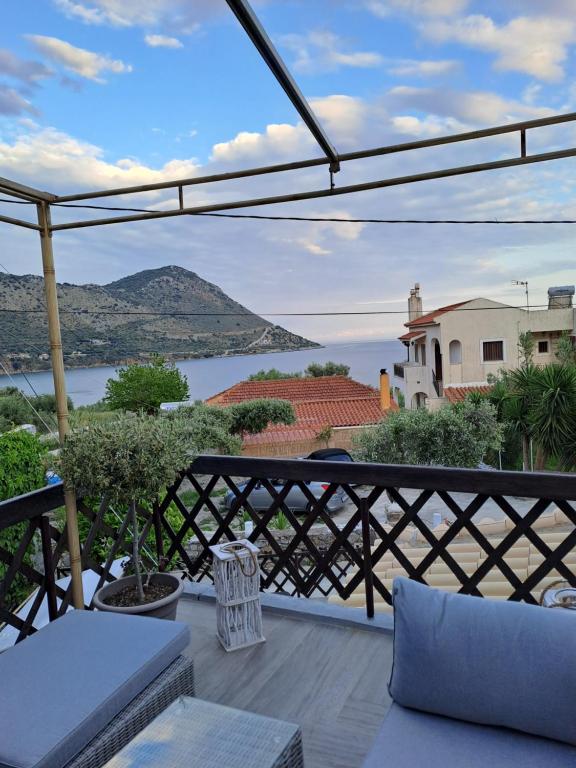 a balcony with a view of the water and mountains at Plavoukos'house in Kótronas