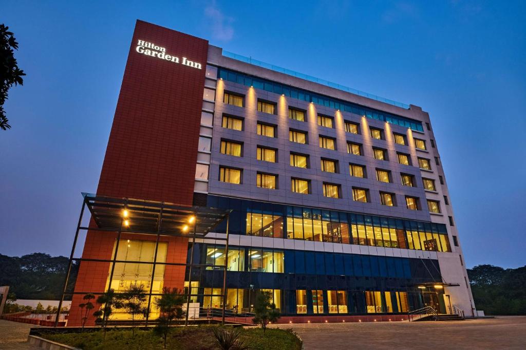 a building with a sign on the side of it at Hilton Garden Inn Lucknow in Lucknow