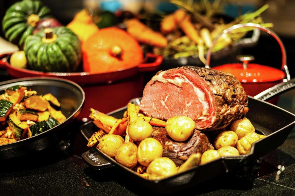 a meal of meat and vegetables on a table at Hilton Osaka Hotel in Osaka