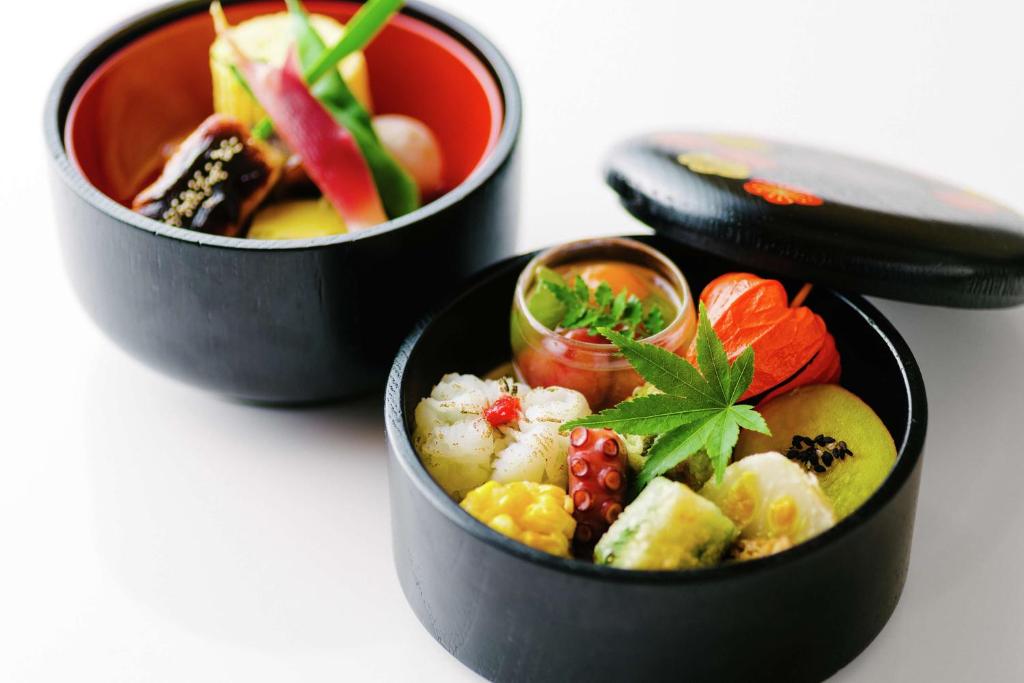 three bowls of food sitting on a table at Hilton Osaka Hotel in Osaka